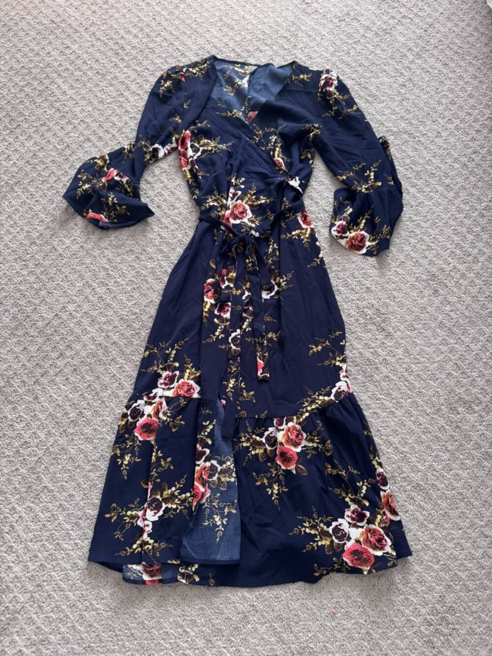 Navy blue floral wrap dress features a charming pink and red rose print